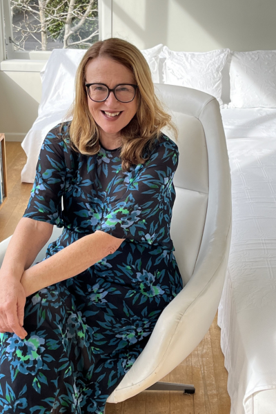 Nicky Pellegrino sitting on a white armchair